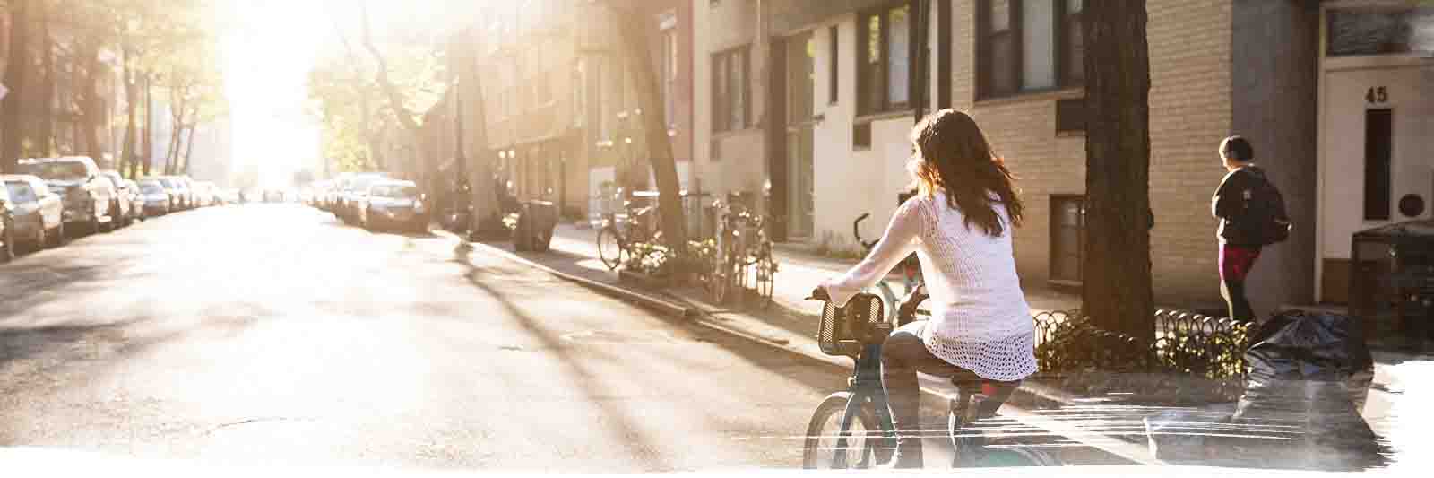 Girl riding her bicycle in the residential street