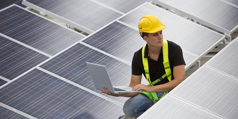 man working on solar panel