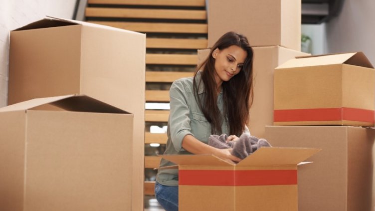 Lady packing the luggage for moving to other place