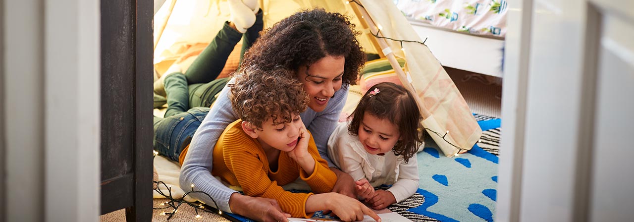 woman with children reading a book