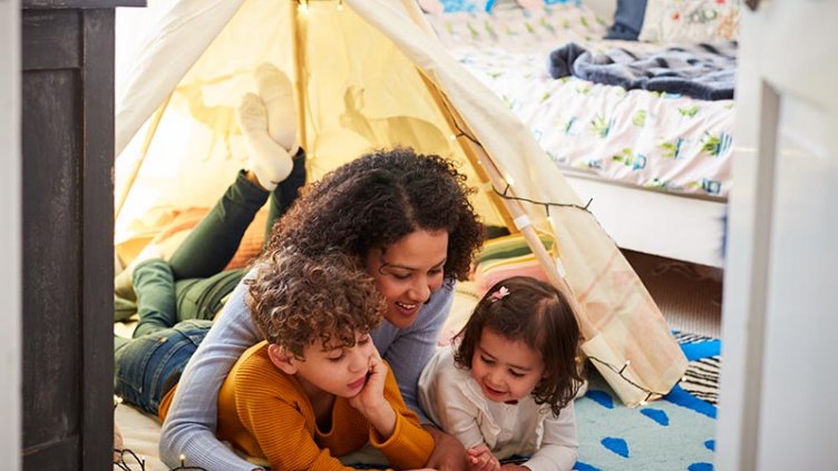 woman with children reading a book