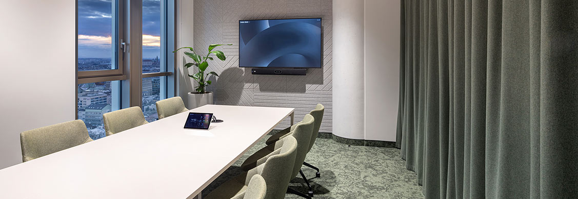 A spacious conference room with chairs and LED screen.