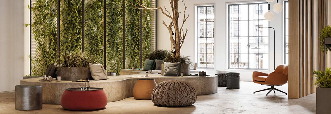 Lobby of a contemporary office building showcasing a large green wall, enhancing the space with natural elements.