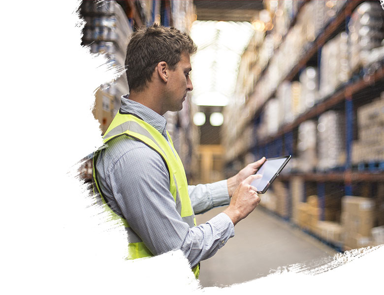 Warehouse worker on tablet analysing stock