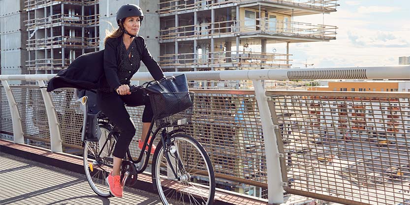 A lady is riding a bicycle