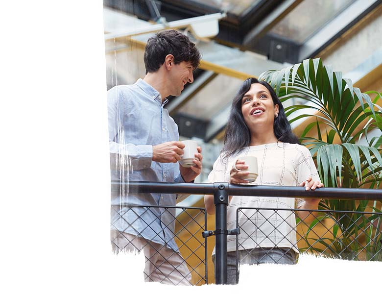 A man and woman holding coffee mugs