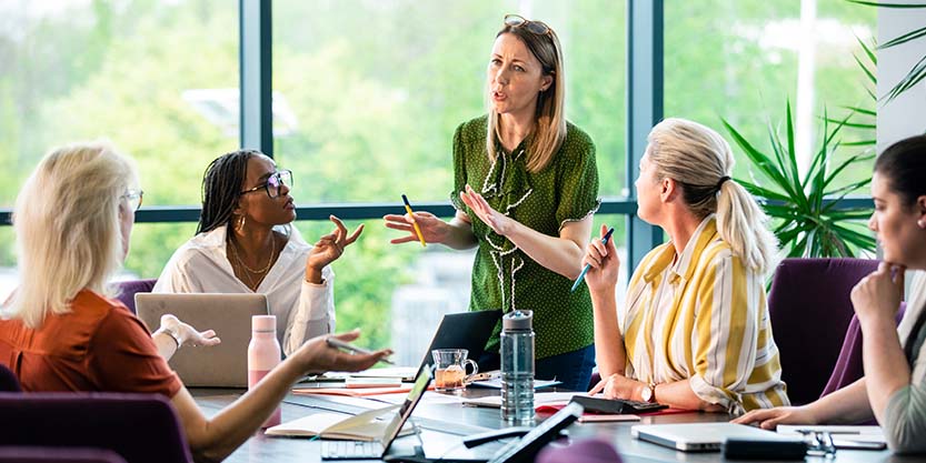 Team gathered around table discussing business opportunity 