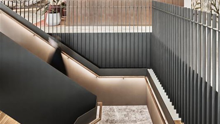 A stylish staircase constructed from wood and metal, highlighting a blend of natural and industrial elements.