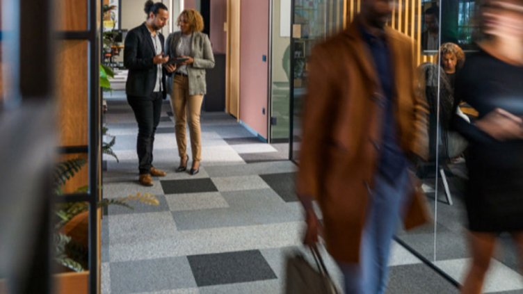 People discussing on the corridor at office