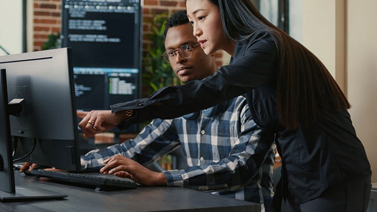 Two people looking at the monitor