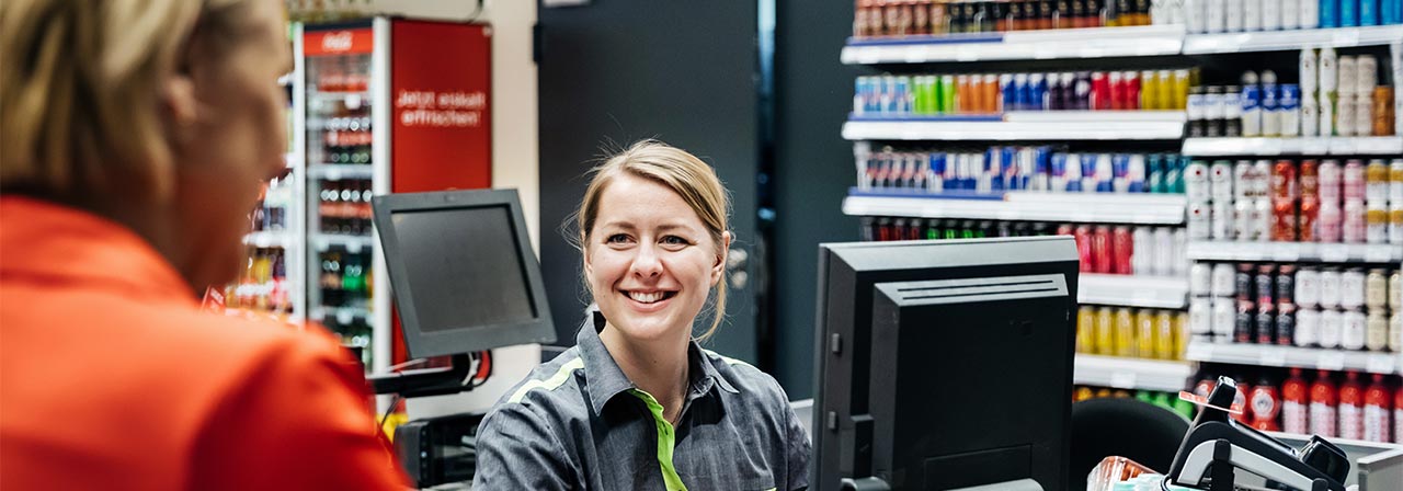 People communicating at supermarket store