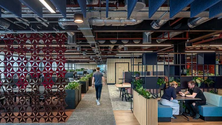 An office interior showcasing a mix of blue and red furniture, contributing to a colorful and energetic environment.